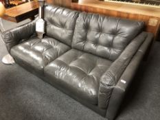 An Alexander & James leather button two seater settee.