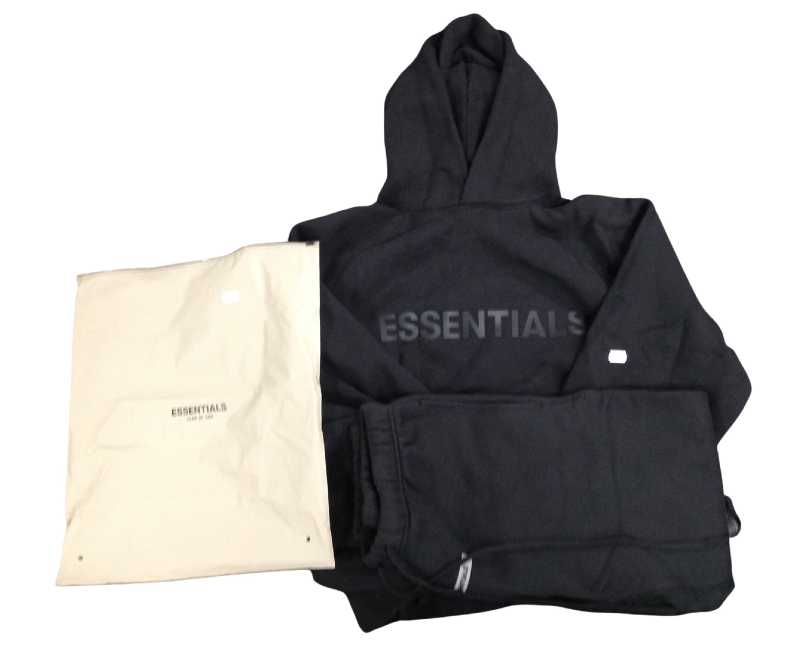 An Essentials black two piece tracksuit with retail bag.