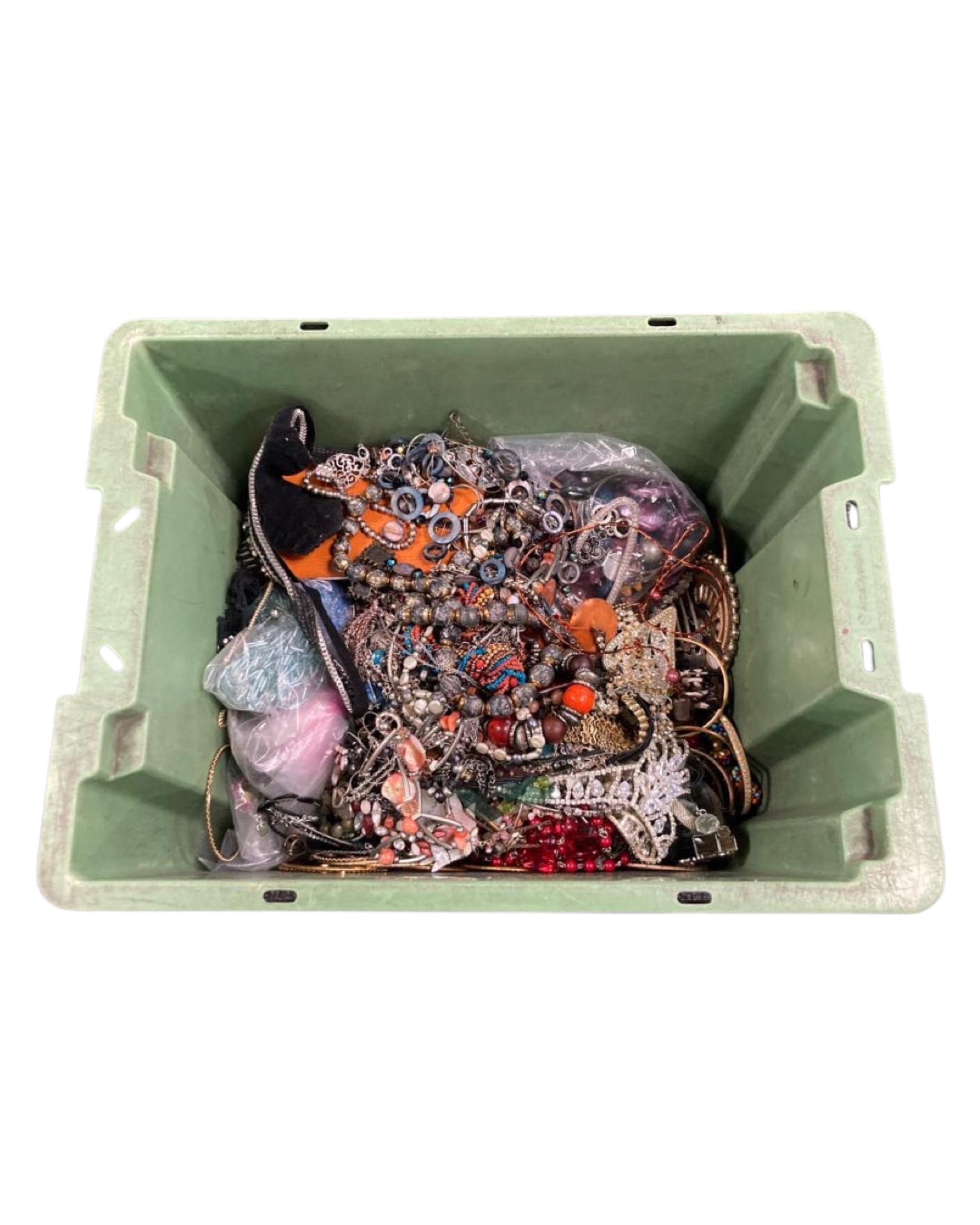 A box of costume jewellery including necklaces.