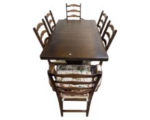 An Ercol draw-leaf table together with six chairs