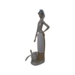 A Lladro figure of a lady standing with geese.