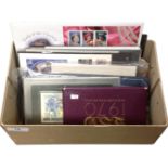 A box containing First Day coin covers, Royal Bank of Scotland one pound note,