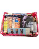 A box containing books and DVDs including Harry Potter, a book on John Lennon etc.