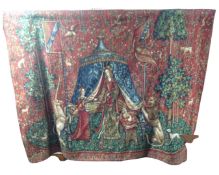 A traditional style embroidered tapestry hanging on metal rail