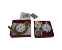 A reproduction pocketwatch by Timex together with a Smiths chrome plated pocketwatch and a Masonic