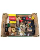 A box containing tourist wooden carvings, cutlery, Rubiks cube etc.