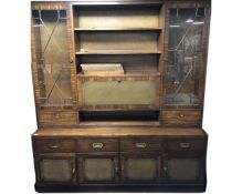 A reproduction mahogany wall cabinet with fall front and storage base
