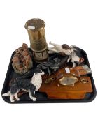 A tray containing modern dog ornaments, a desk clock, a reproduction pistol and a miner's lamp.