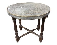 An Indian brass topped folding table