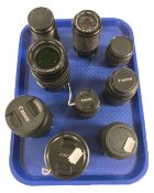 Nine assorted camera lenses including a Carl Zeiss Jena DDR 135mm f/3.