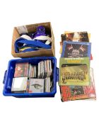 A box of CDs and vinyl records together with kick boxing items.