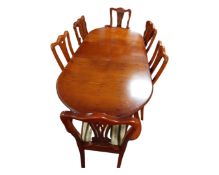 A reproduction mahogany twin pedestal dining table together with six chairs