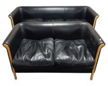 A black leather three seater and two seater settee