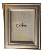 One crate containing seventeen Xenos silver finish MDF 15 cm x 18 cm photo frames,