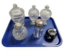 A tray containing two silver lidded glass bottles, a perfume bottle and further glass jars.