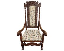 A late 19th century Continental heavily carved beech armchair.