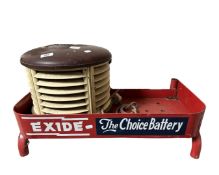 An enamelled metal battery stand together with a vintage halogen heater