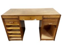 An early 20th century Continental beech twin pedestal desk with sliding shutter doors and central