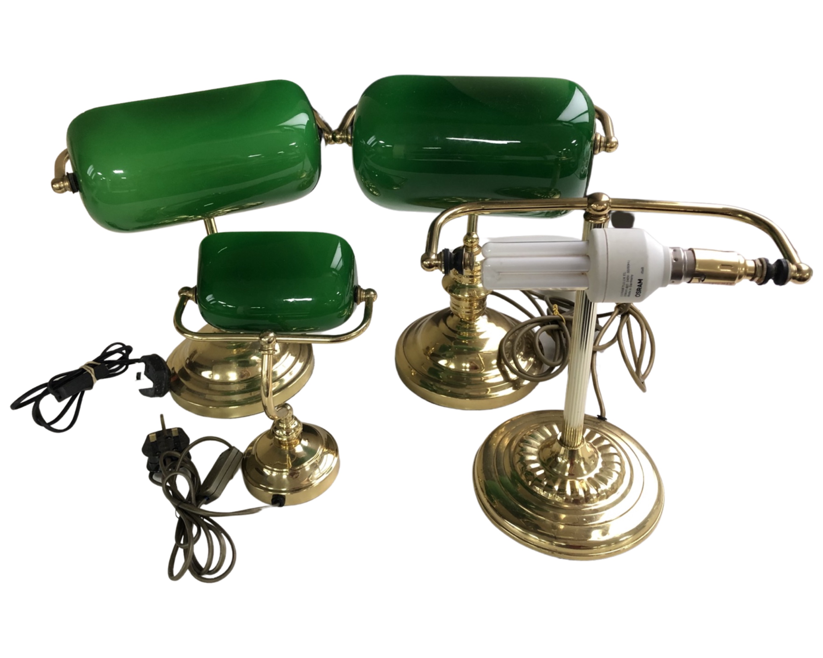 Four brass banker's desk lamps, three with shades.