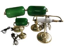 Four brass banker's desk lamps, three with shades.