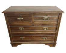 An Edwardian oak chest of four drawers.