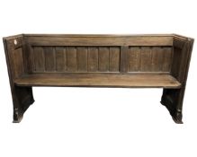 A 19th century carved oak church pew, originally from Newcastle Cathedral,
