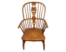 An elm and beech spindle back kitchen armchair.