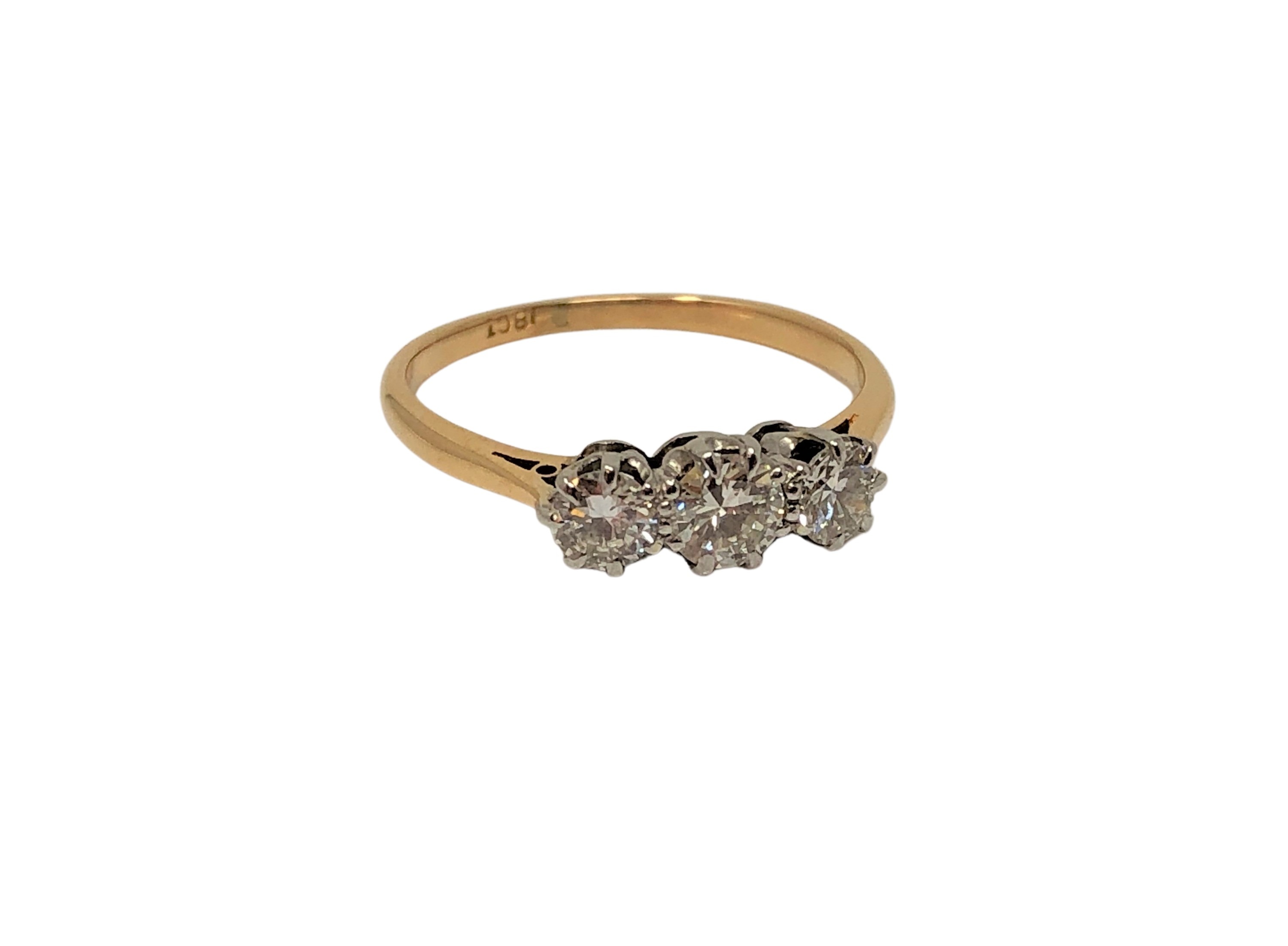 An 18ct gold three stone diamond ring, size M CONDITION REPORT: 2.