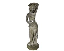 A weathered concrete figure of an exotic dancer,