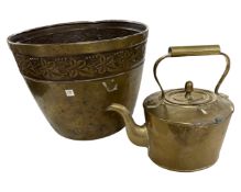 An embossed brass plant pot together with a brass kettle.