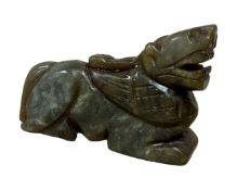 A carved jade figure of a tiger.