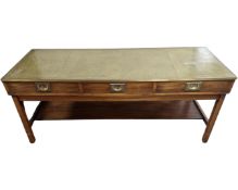A rectangular campaign style coffee table fitted with green leather inset top and three drawers
