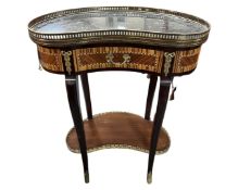 A French kidney shaped side table with gilt metal mounts, black marble top and brass gallery.