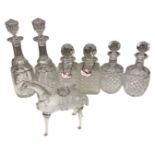 A tray containing three pairs of crystal decanters and a glass wine jug in the form of a horse.