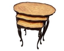A French nest of three inlaid walnut tables on cabriole legs.