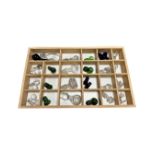 A pine drawer containing a quantity of glass decanter stoppers.
