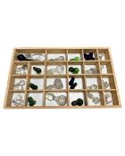 A pine drawer containing a quantity of glass decanter stoppers.