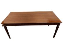 A reproduction rectangular mahogany coffee table on tapered legs.