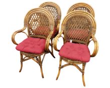 A set of four wicker armchairs.