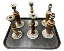 A tray containing six wooden and plated metal candlesticks.