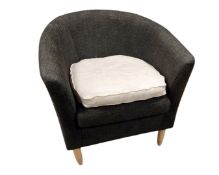 A tub chair in grey upholstery.