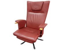 A red leather upholstered swivel armchair.
