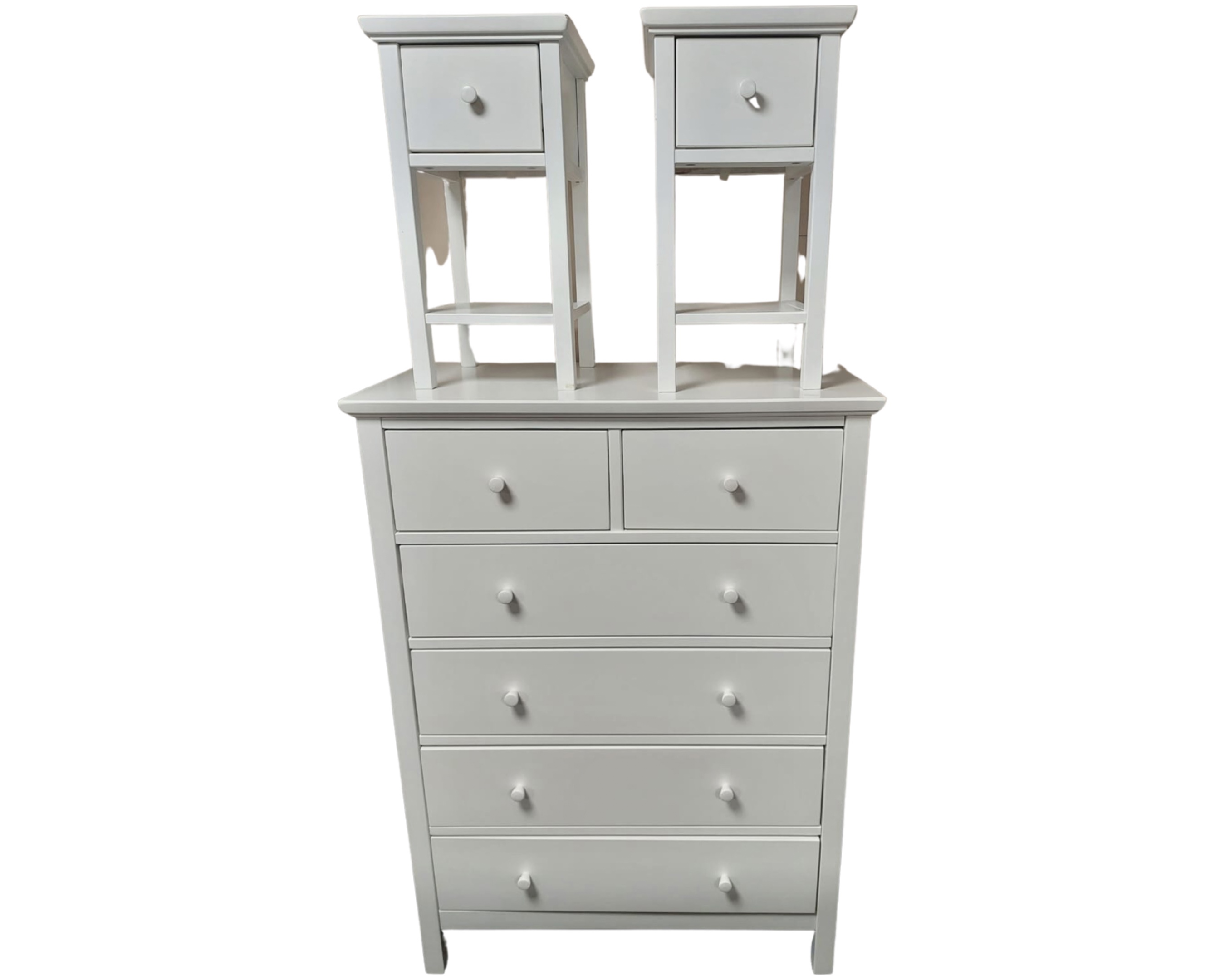 A contemporary white six drawer chest together with a pair of matching bedside tables
