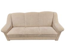 A contemporary three seater settee in oatmeal fabric upholstery.