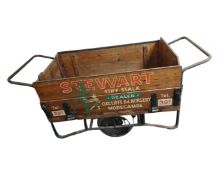 A large wooden cart on wheels with painted advertising decoration