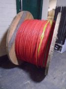 A large spool of red fibre optic cable.