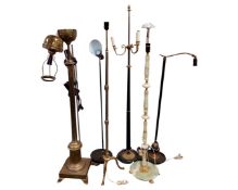 Seven assorted Continental floor lamps including brass and onyx examples.