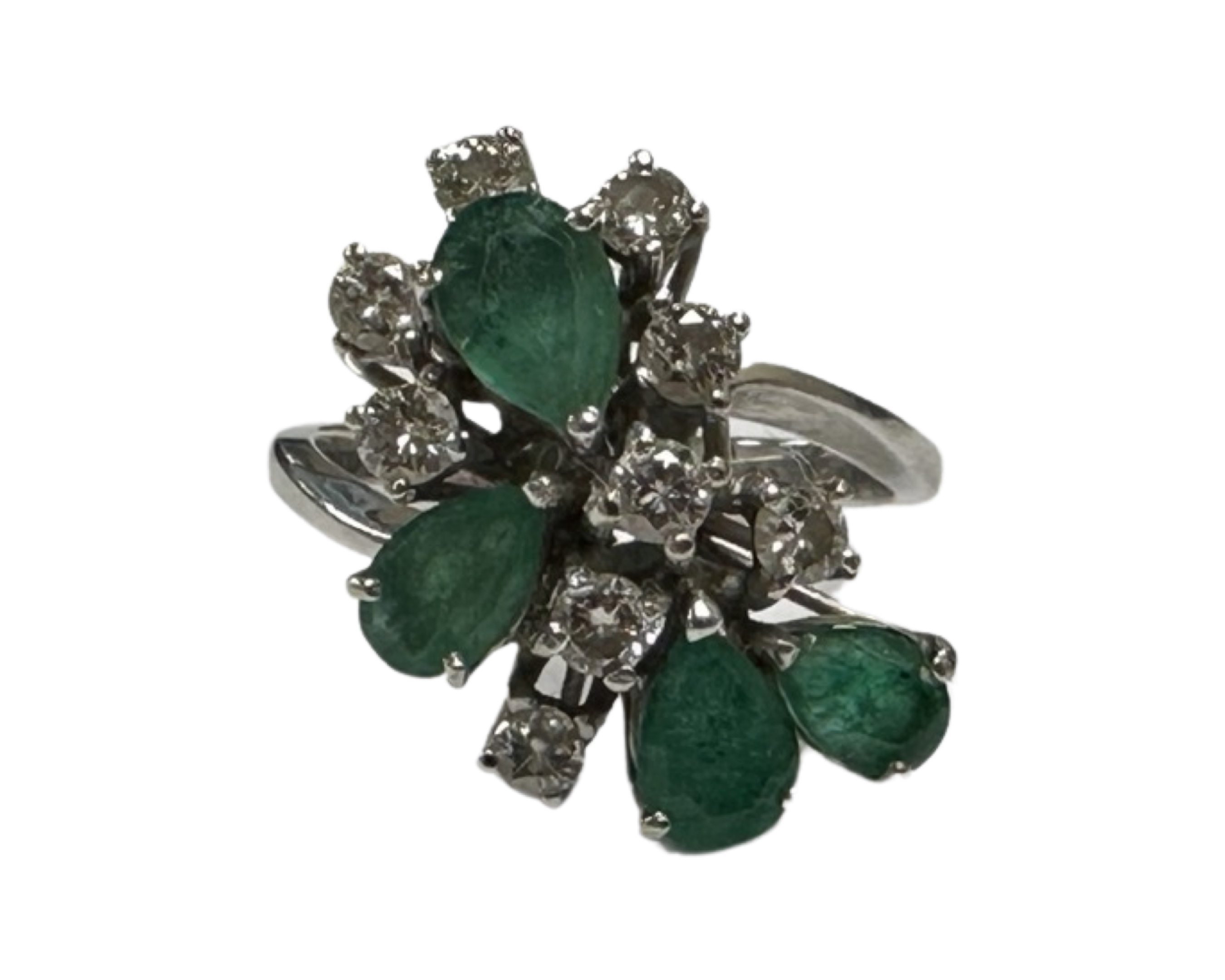 An 18ct white gold diamond and emerald ring, the floral design with nine diamonds,