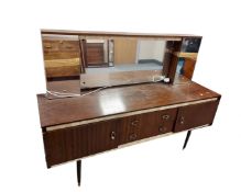 A 1970s teak effect mirror back dressing table.