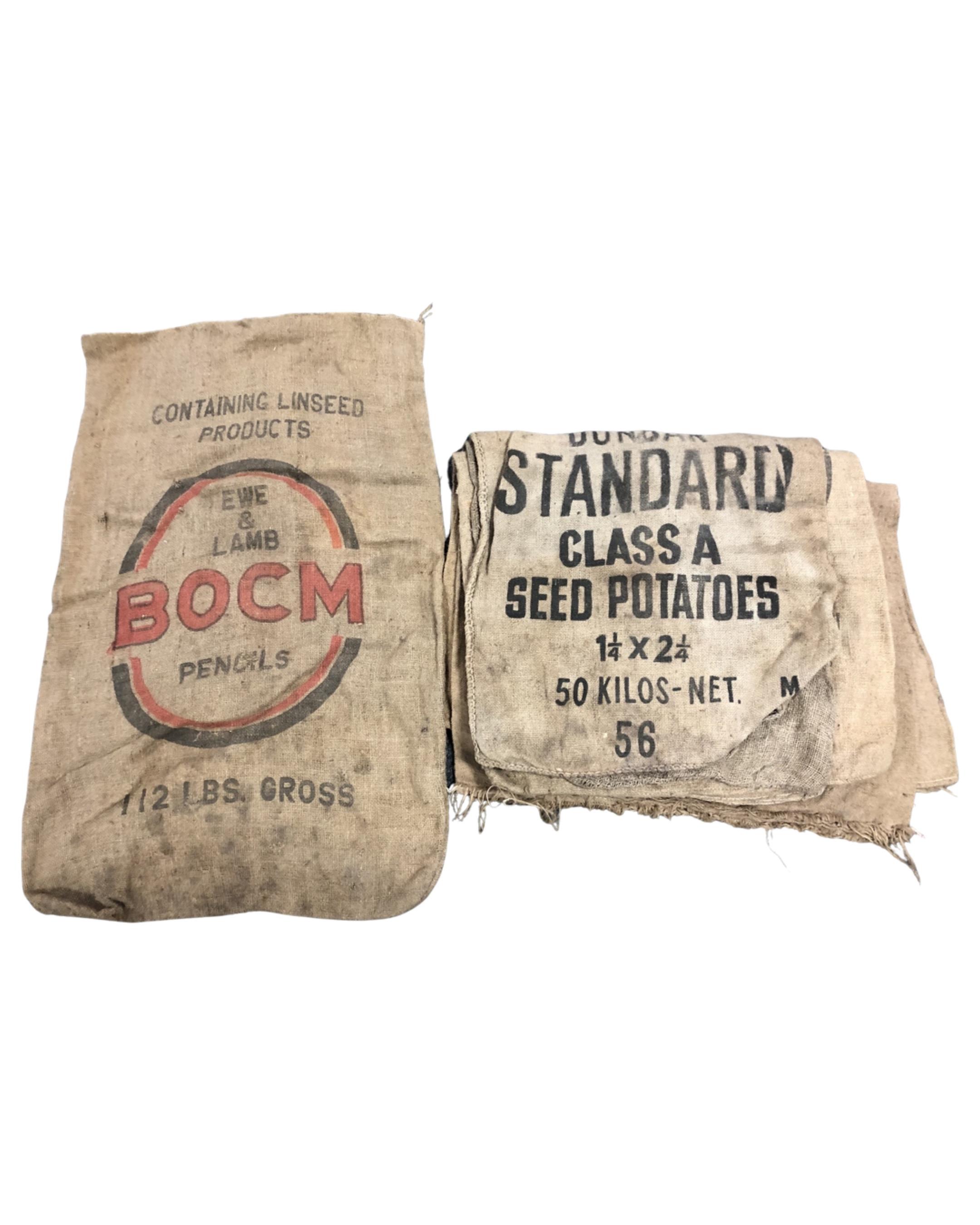 A box containing eight Hessian sacks, five bearing advertising.